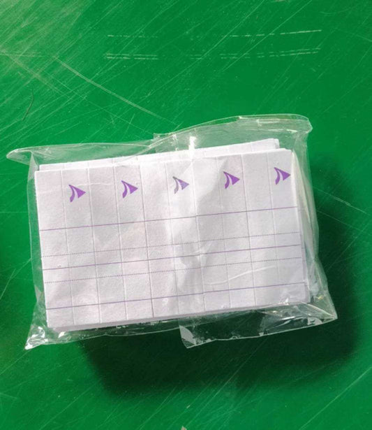 Velcro wrist strap in packaging on green background.